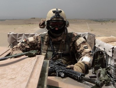 A German soldier holds his weapon as he rides an amoured vehicle on June 3, 2010 in Shir Khan, Afghanistan.