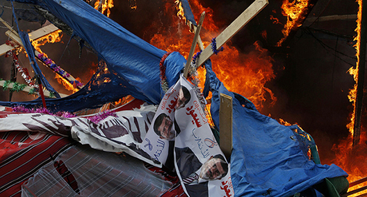 A protest tent burns as Egyptian security forces moved in to disperse supporters of Egypt's ousted president Mohamed Morsi by force in a huge camp near Rabaa al-Adawiya mosque in eastern Cairo on August 14, 2013.