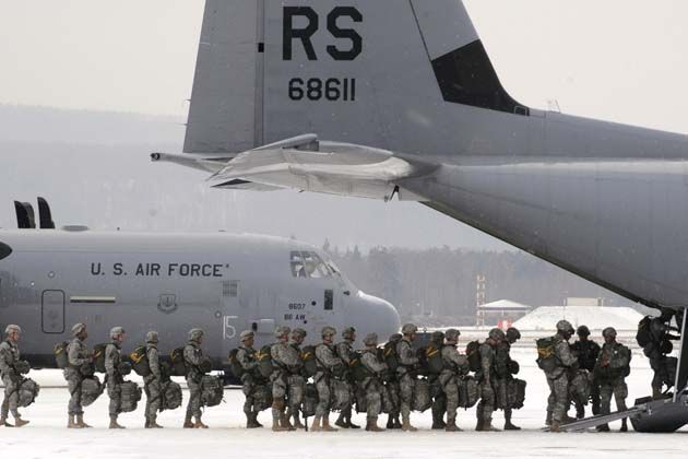 Army paratroopers file into a C-130J Super Hercules