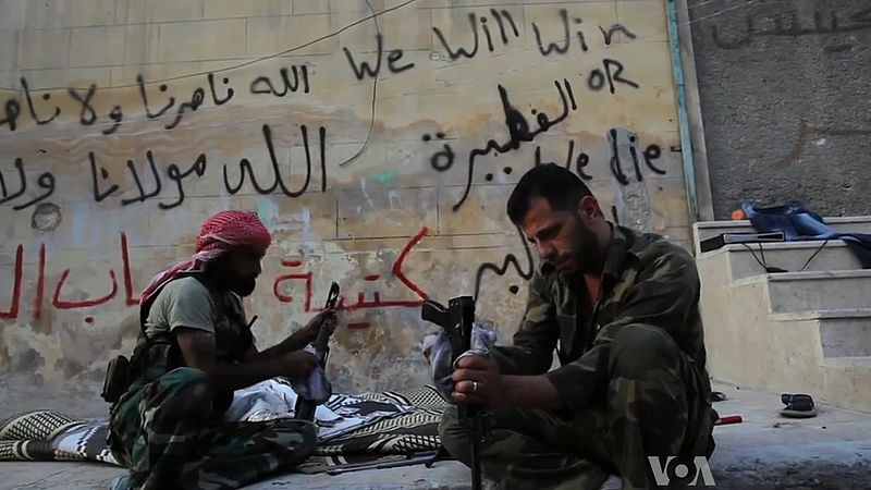 FSA fighters cleaning their AK-47s in Aleppo