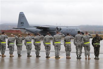 Airmen salute  C-130E Hercules departing Ramstein AFB
