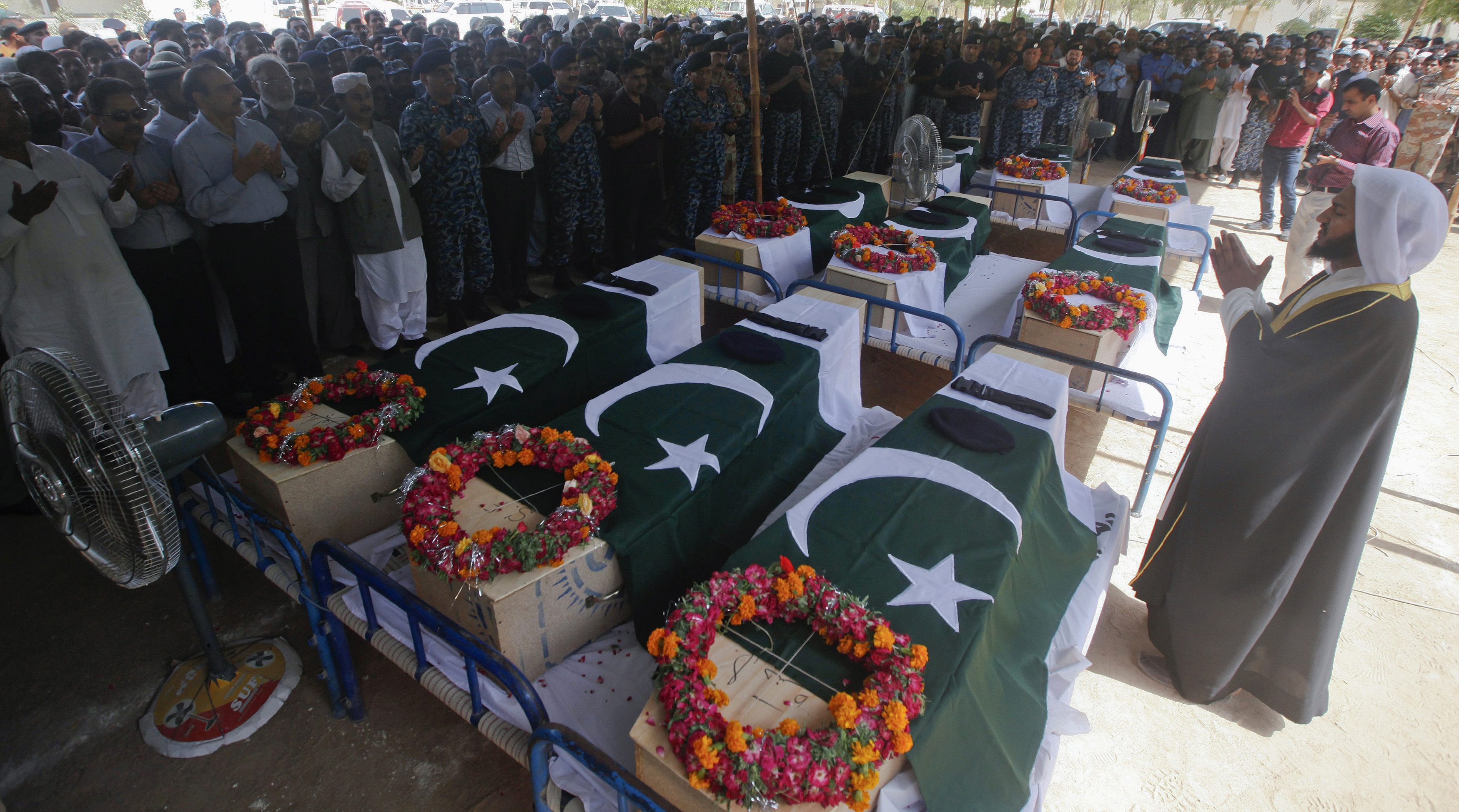 Relatives and colleagues of Airport Security Force soldiers killed on Sunday's Taliban attack on Jinnah International Airport, offer funeral prayers on June 9. Militant fighters stormed the airport disguised as security forces. REUTERS/Athar Hussain