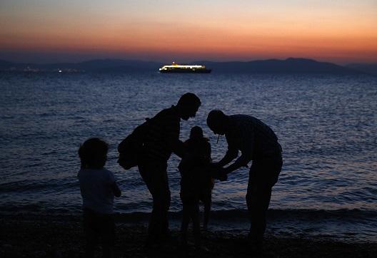 Photo: Syrian refugees arrive at the Greek island of Kos on a dinghy. Picture taken 12 Aug, 2015. Reuters/Yannis Behrakis 