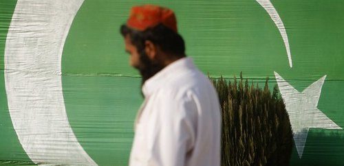 Man in front of Pakistan flag