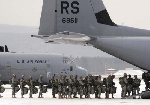 Army paratroopers file into a C-130J Super Hercules