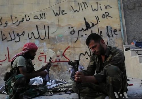 FSA fighters cleaning their AK-47s in Aleppo
