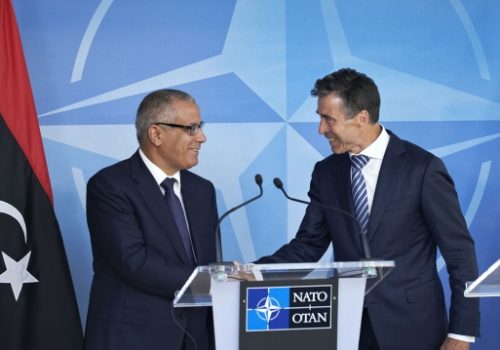 US Secretary of State John Kerry shakes hands with Libyan Prime Minister Ali Zidan after addressing reporters at the US Department of State in Washington, DC, on March 13, 2013.