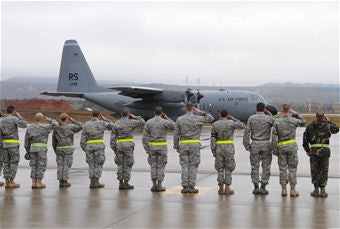 Airmen salute C-130E Hercules departing Ramstein AFB