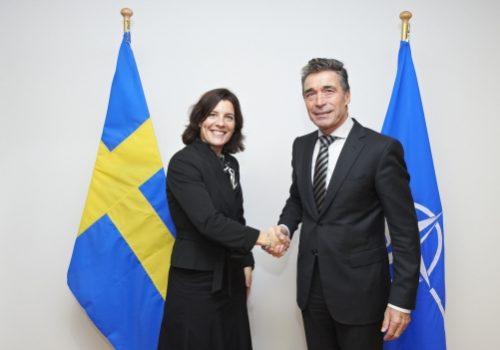 Swedish Defense Minister Karin Enstrom and NATO Secretary General Anders Fogh Rasmussen