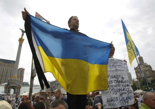 Ukrainians hold flags and signs bearing their latest concerns as they gather in a veche (people’s assembly) at Maidan Nezalezhnosti on Sunday, June 1. The meeting was the latest in a long public debate over the future of the Maidan movement that toppled the corrupt presidency of Viktor Yanukovych in February. REUTERS/Valentyn Ogirenko