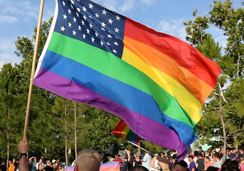 A rainbow U.S. flag is held up during a vigil for the Pulse night club victims in Orlando, Florida, U.S. on June 19, 2016. (REUTERS/Carlo Allegri/File Photo)