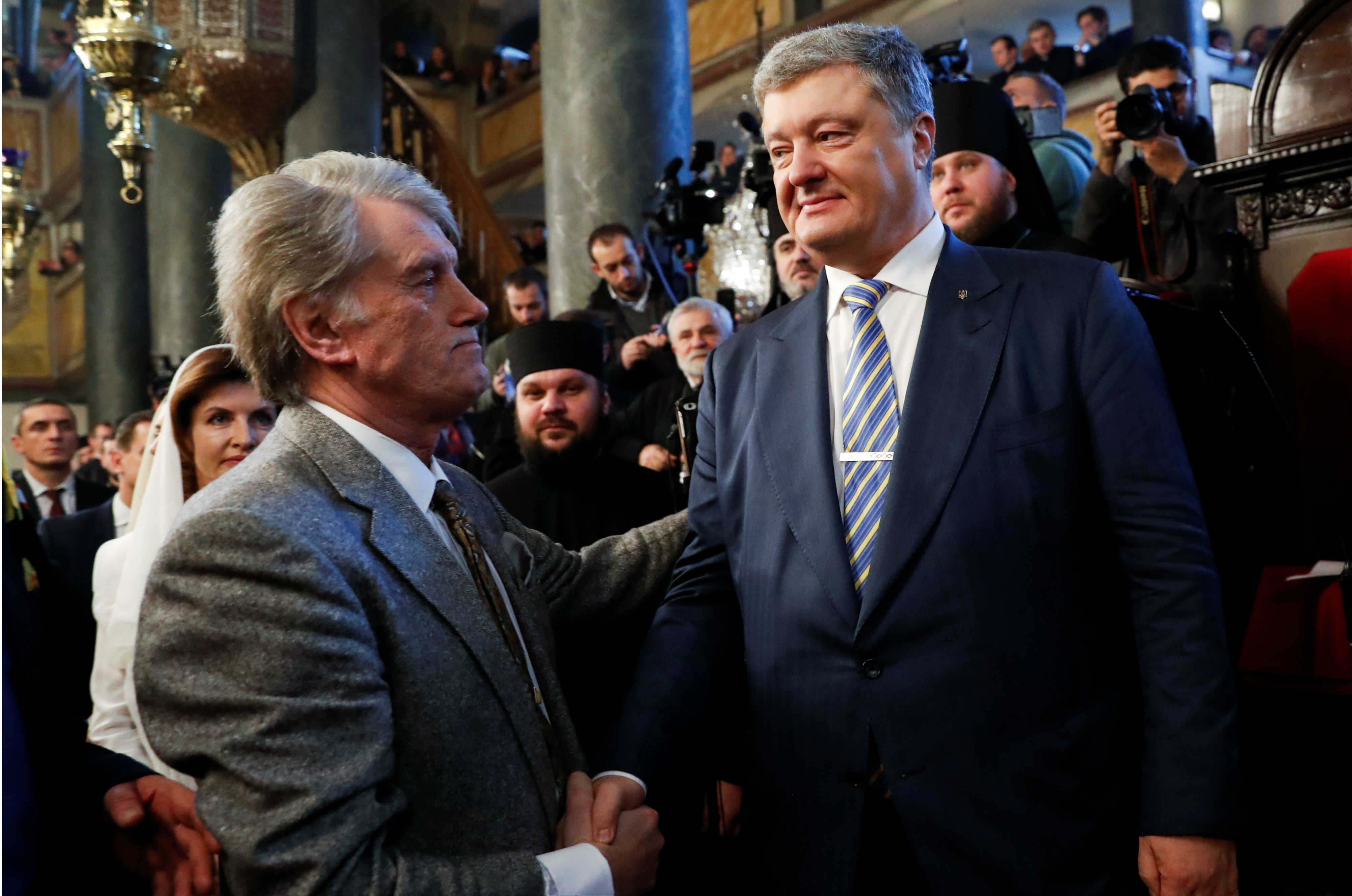 Ukrainian President Petro Poroshenko shakes hands with Former Ukrainian President Viktor Yushchenko after the Epiphany mass at the Patriarchal Cathedral of St. George in Istanbul, Turkey January 6, 2019. REUTERS/Murad Sezer