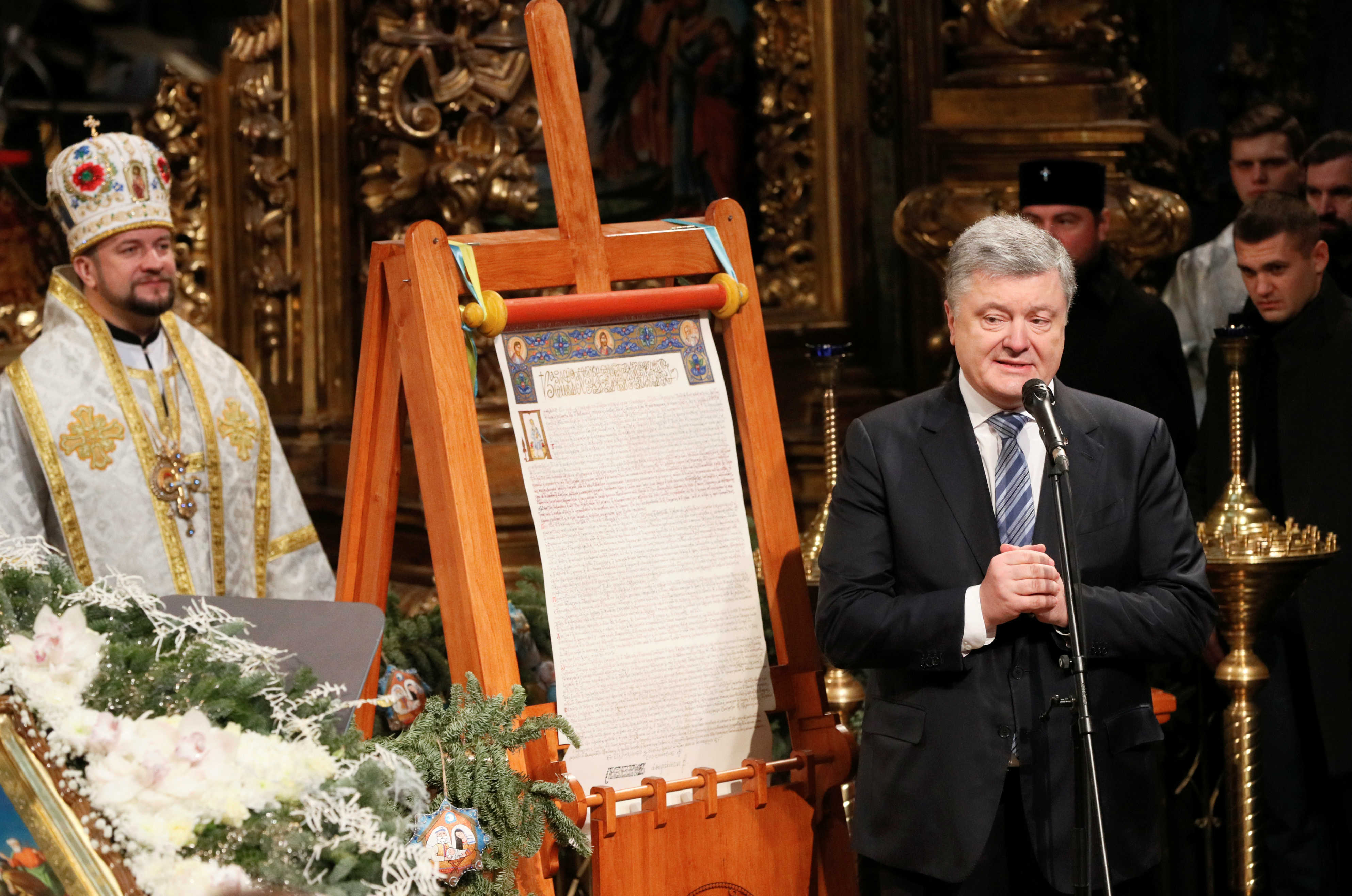 Ukrainian President Petro Poroshenko delivers a speech while standing next to Tomos, a decree granting the Orthodox Church of Ukraine independence, during the Orthodox Christmas service at the Saint Sophia's Cathedral in Kyiv, Ukraine January 7, 2019. REUTERS/Valentyn Ogirenko