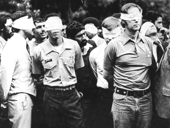 Blindfolded U.S. hostages and their Iranian captors outside the U.S. embassy in Tehran