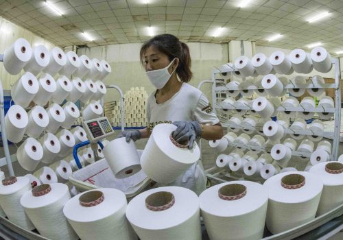 A worker works at a textile factory in Qingzhou city, east China's Shandong province, 18 March 2020.