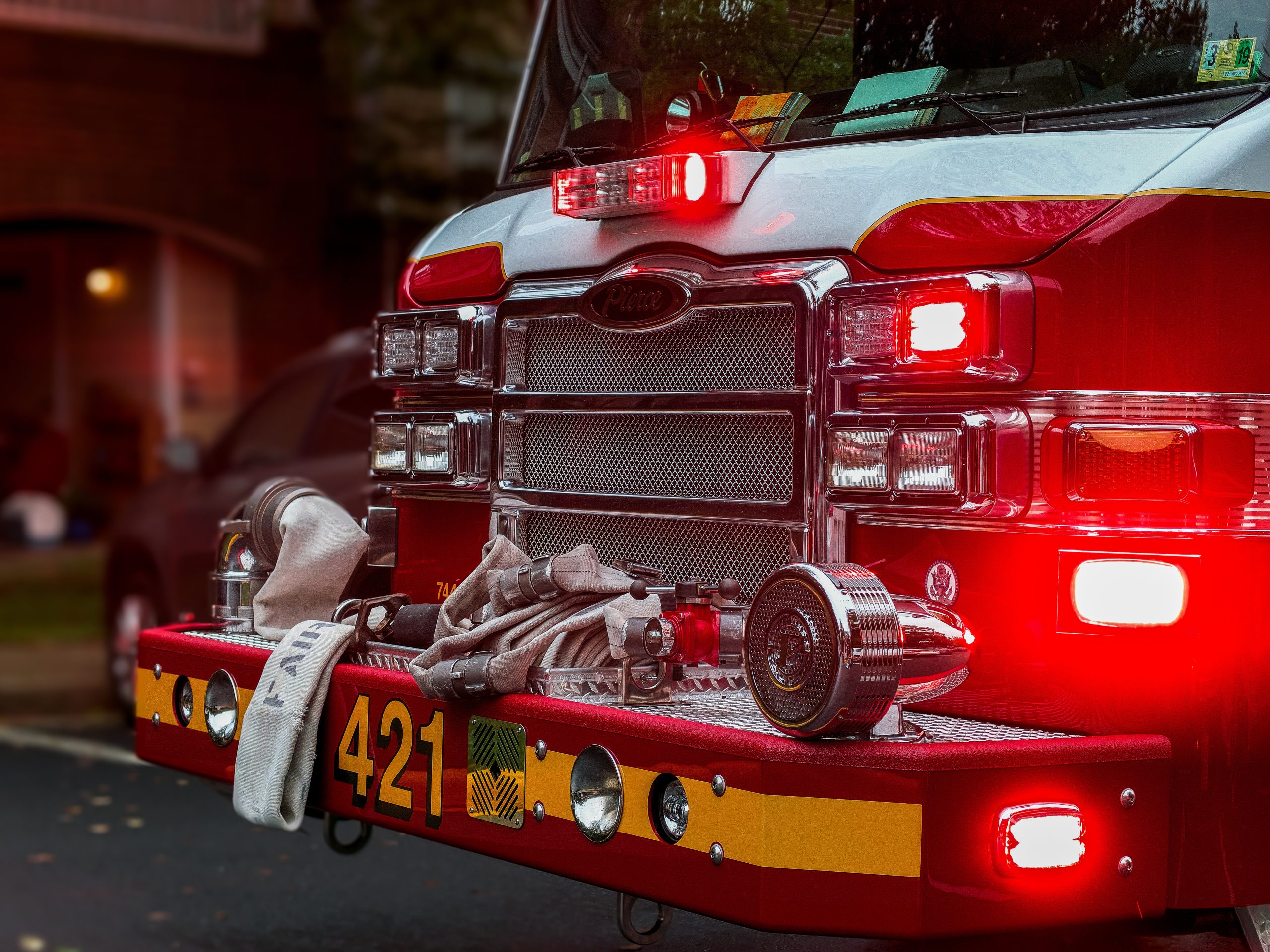 gtc front of a fire engine with the lights glowing