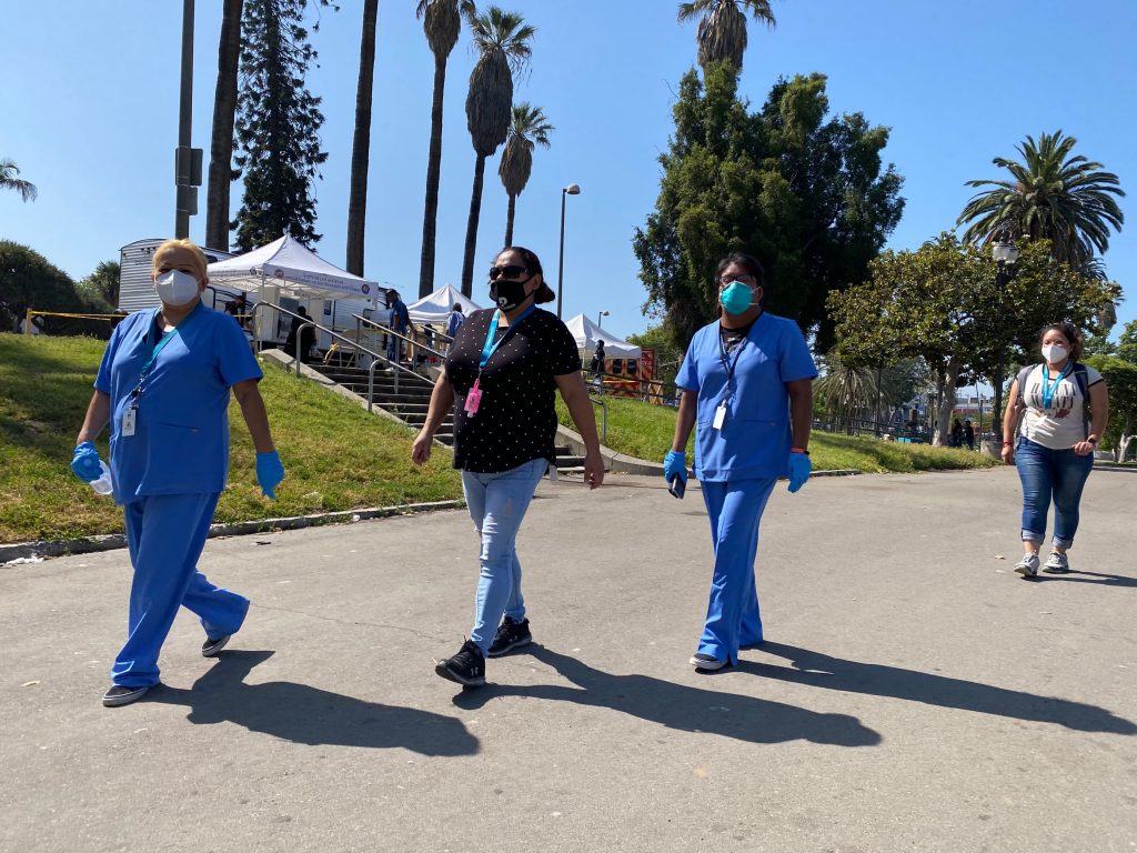 Staff in PPE conducting community outreach