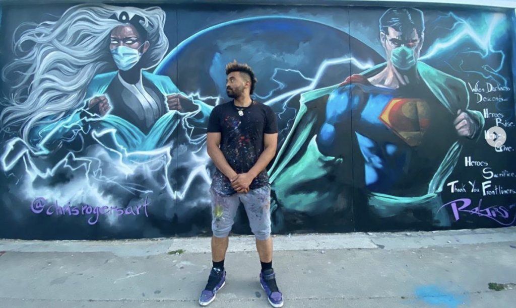 Man in front of wall with graffiti