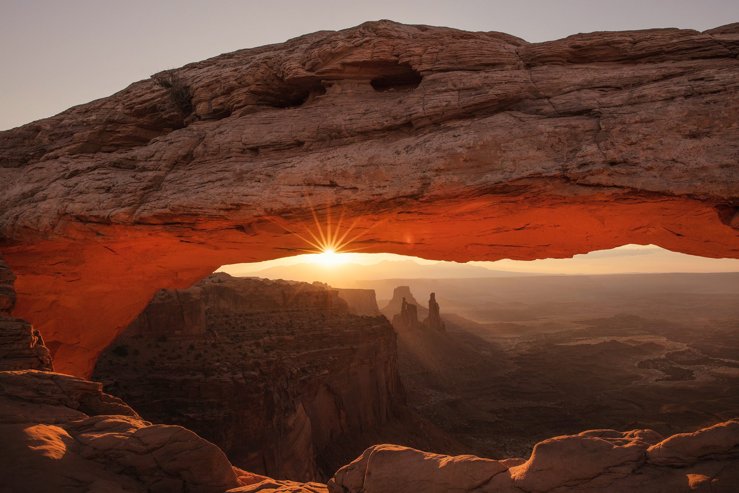 gtc photo of sun peaking through a large rock formation