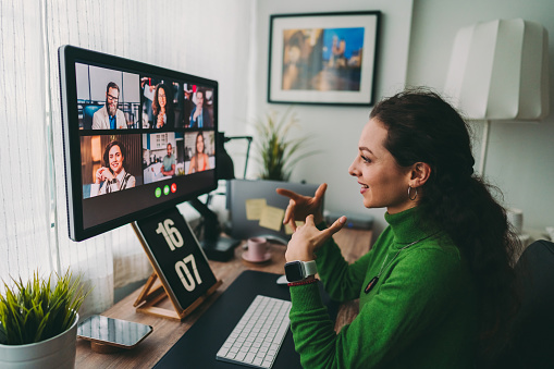 Stock image of a woman participating in a virtual meetingint