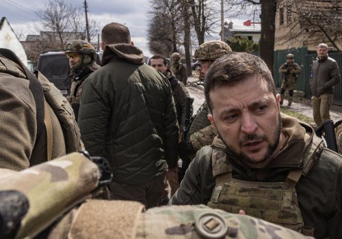 Ukraine's President Volodymyr Zelenskiy speaks as he is surrounded by Ukrainian servicemen as Russia's invasion of Ukraine continues, in Bucha, outside Kyiv, Ukraine, April 4, 2022. REUTERS/Marko Djurica