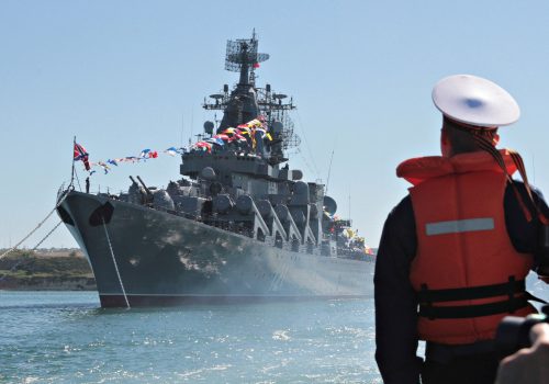 A sailor looks at the Russian missile cruiser Moskva moored in the Ukrainian Black Sea port of Sevastopol, Ukraine 10, 2013. REUTERS/Stringer/File Photo