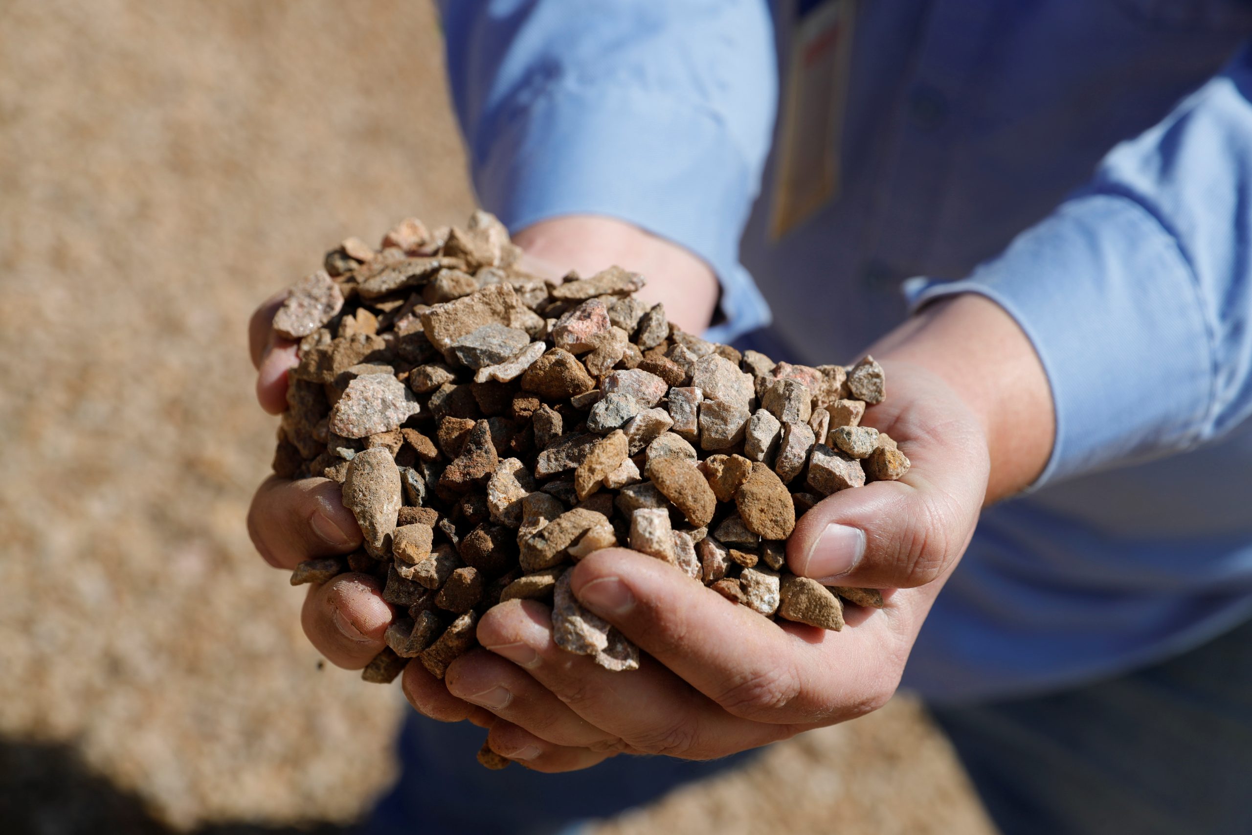 Matt Green, mining/crushing supervisor at MP Materials, displays crushed ore before it is sent to the mill at the MP Materials rare earth mine in Mountain Pass, California, U.S. January 30, 2020. Picture taken January 30, 2020. REUTERS/Steve Marcus - RC2N9G9KXQV4