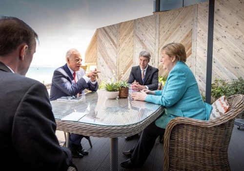 Biden, Merkel, and their advisors at a table