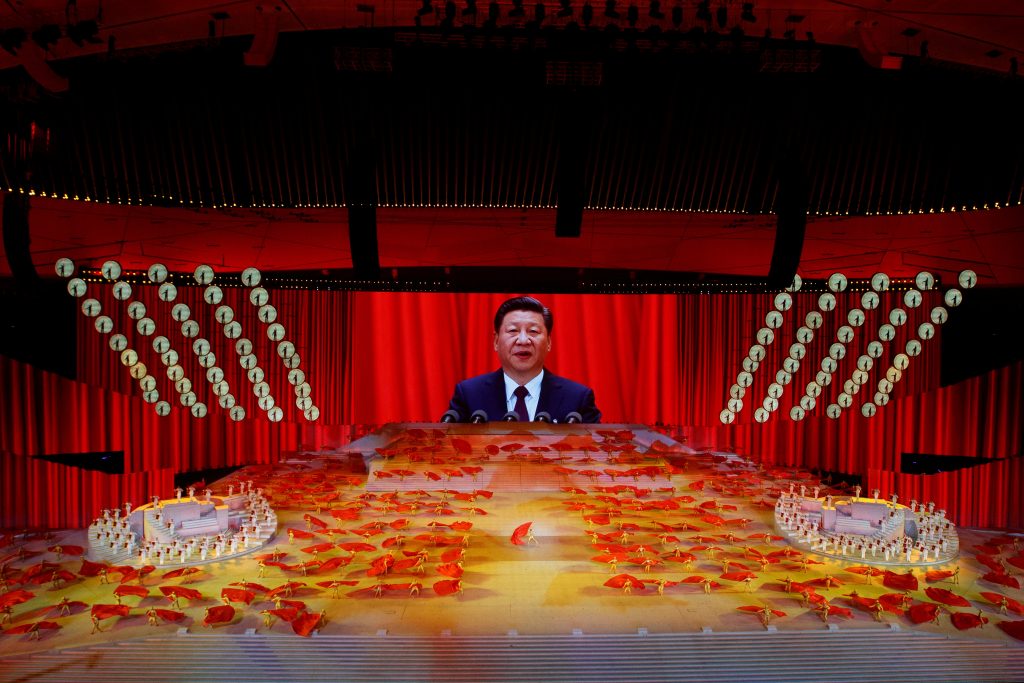 A screen shows Chinese President Xi Jinping 