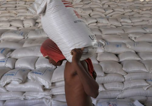 Man carries a sack of wheat at World Food Program warehouse in Gode
