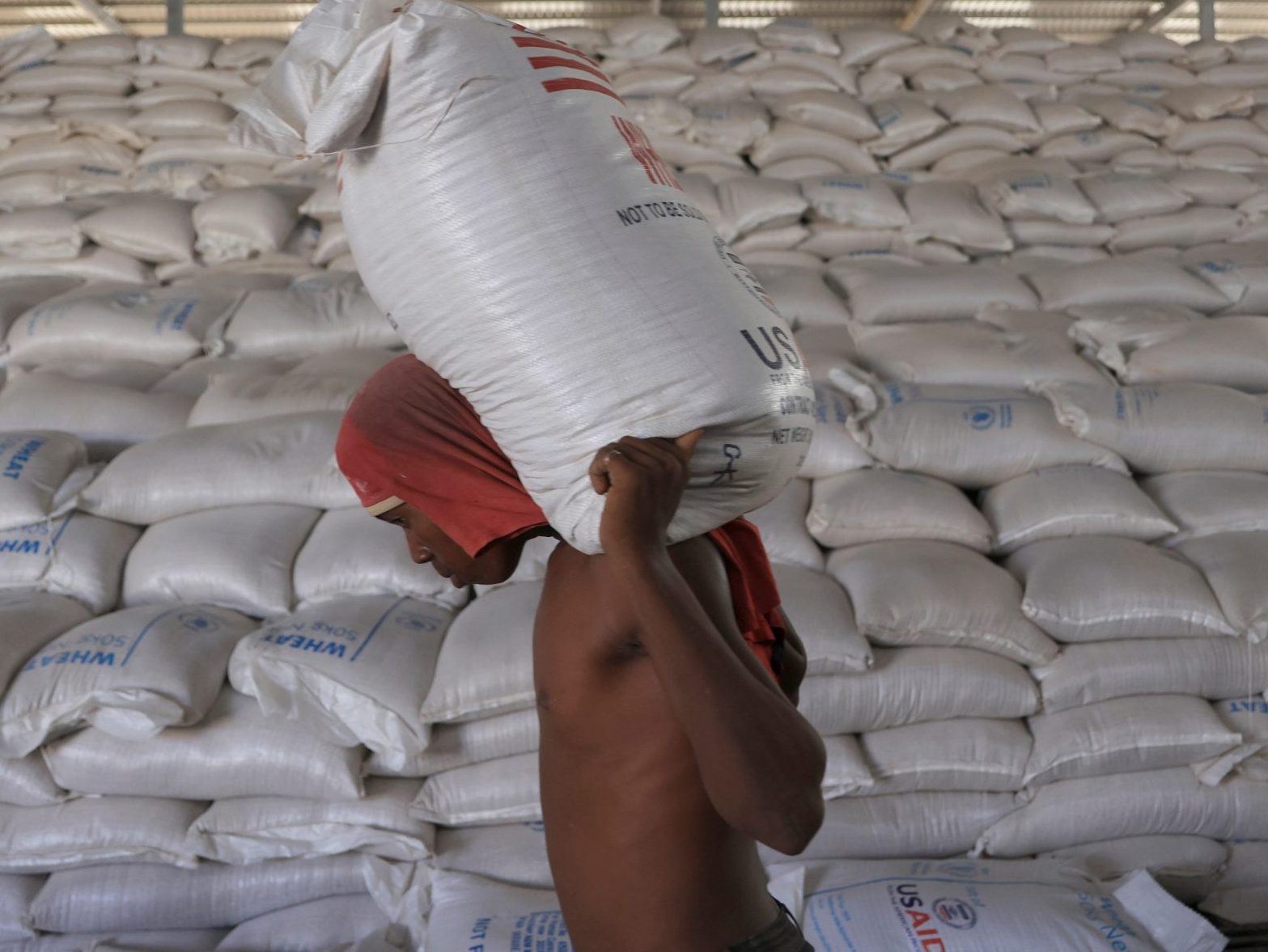 Man carries a sack of wheat at World Food Program warehouse in Gode
