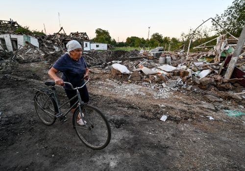 A woman pushes a bicycle past residential buildings destroyed in a Russian missile attack on Chaplyne urban-type settlement, Dnipropetrovsk Region, central Ukraine, August 24, 2022. The strike on the residential sector and the railway station carried out by Russian occupiers on Ukraine's 31st Independence Day claimed the lives of 25 people, including an 11-year-old boy and a six-year-old girl, while 31 people got injured. Photo by Dmytro Smolienko/Ukrinform/ABACAPRESS.COMNo Use Russia.