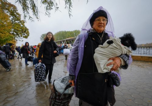 Civilians evacuated from the Russian-controlled city of Kherson walk from a ferry to board a bus heading to Crimea, in the Russian-controlled town of Oleshky, Ukraine, October 23, 2022. (Source: REUTERS/Alexander Ermochenko)