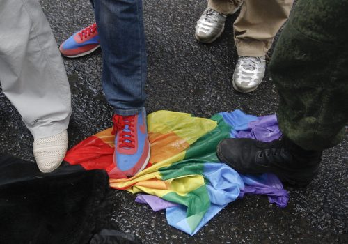 Anti-LGBTQ counter-protesters stomp on a rainbow flag during a protest by gay rights activists in central Moscow, June 11, 2013. (Source: Reuters/Maxim Shemetov)