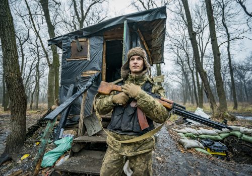 Ukrainian soldier with his weapon in a wooden cottage near the Donbas frontlines, Donetsk. (Source: Celestino Arce/NurPhoto via Reuters Connect)