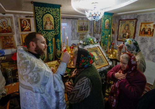 Congregants attend an Orthodox Christmas Eve service in a chapel located in a former residential building in the town of Volnovakha, Russian-controlled Donetsk, January 6, 2023. (SOURCE: Reuters/Alexander Ermochenko/TPX)