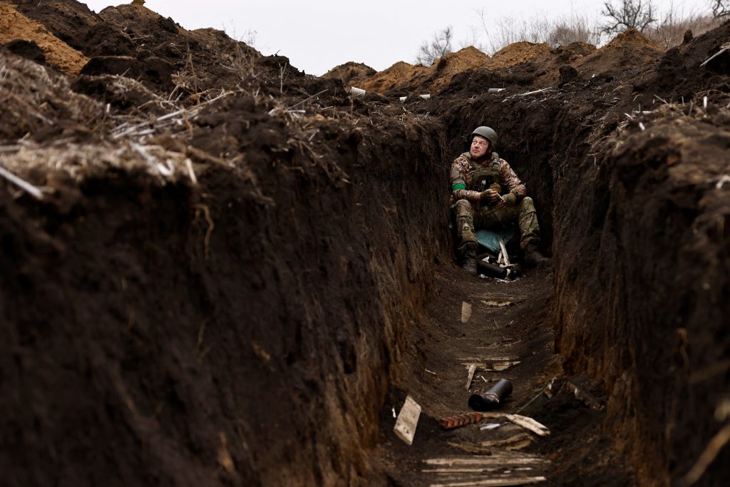A Ukrainian soldier of the Paratroopers' of 80th brigade listens to artillery fire a frontline position near Bakhmut, amid Russia's attack on Ukraine, in Donetsk region, Ukraine March 16, 2023. REUTERS/Violeta Santos Moura