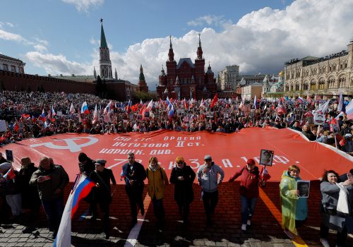 People hold a banner as they attend the Immortal Regiment march on Victory Day in Moscow, May 9, 2022. (Source: Reuters/Maxim Shemetov/File Photo)