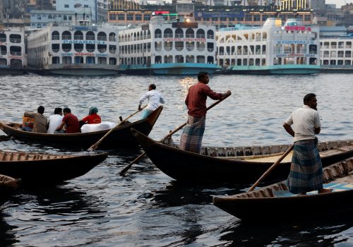 Ferryman Siddique Hawlader (2nd-R), 45, rides his boat on the Buriganga river in Dhaka, Bangladesh, March 29, 2023.