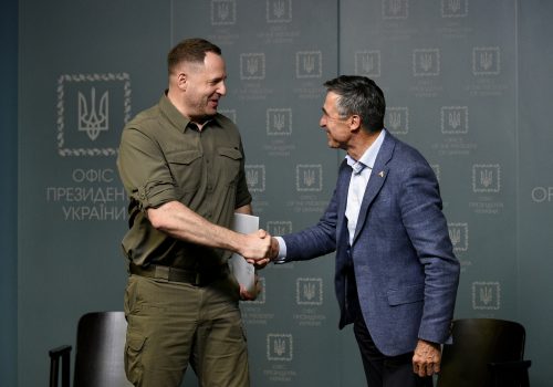 Head of Ukraine's Office of the President Andriy Yermak shakes hands with former NATO Secretary General Anders Fogh Rasmussen.