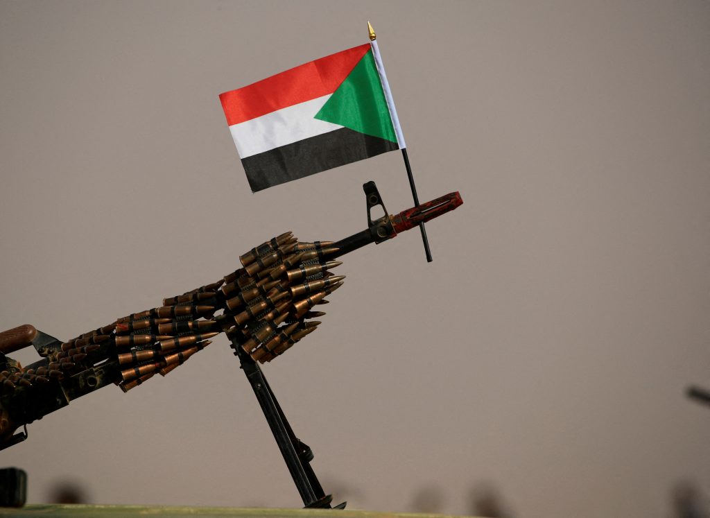 FILE PHOTO: A Sudanese national flag is attached to a machine gun of Paramilitary Rapid Support Forces (RSF) soldiers as they wait for the arrival of Lieutenant General Mohamed Hamdan Dagalo, deputy head of the military council and head of RSF, before a meeting in Aprag village 60, kilometers away from Khartoum, Sudan, June 22, 2019. REUTERS/Umit Bektas//File Photo