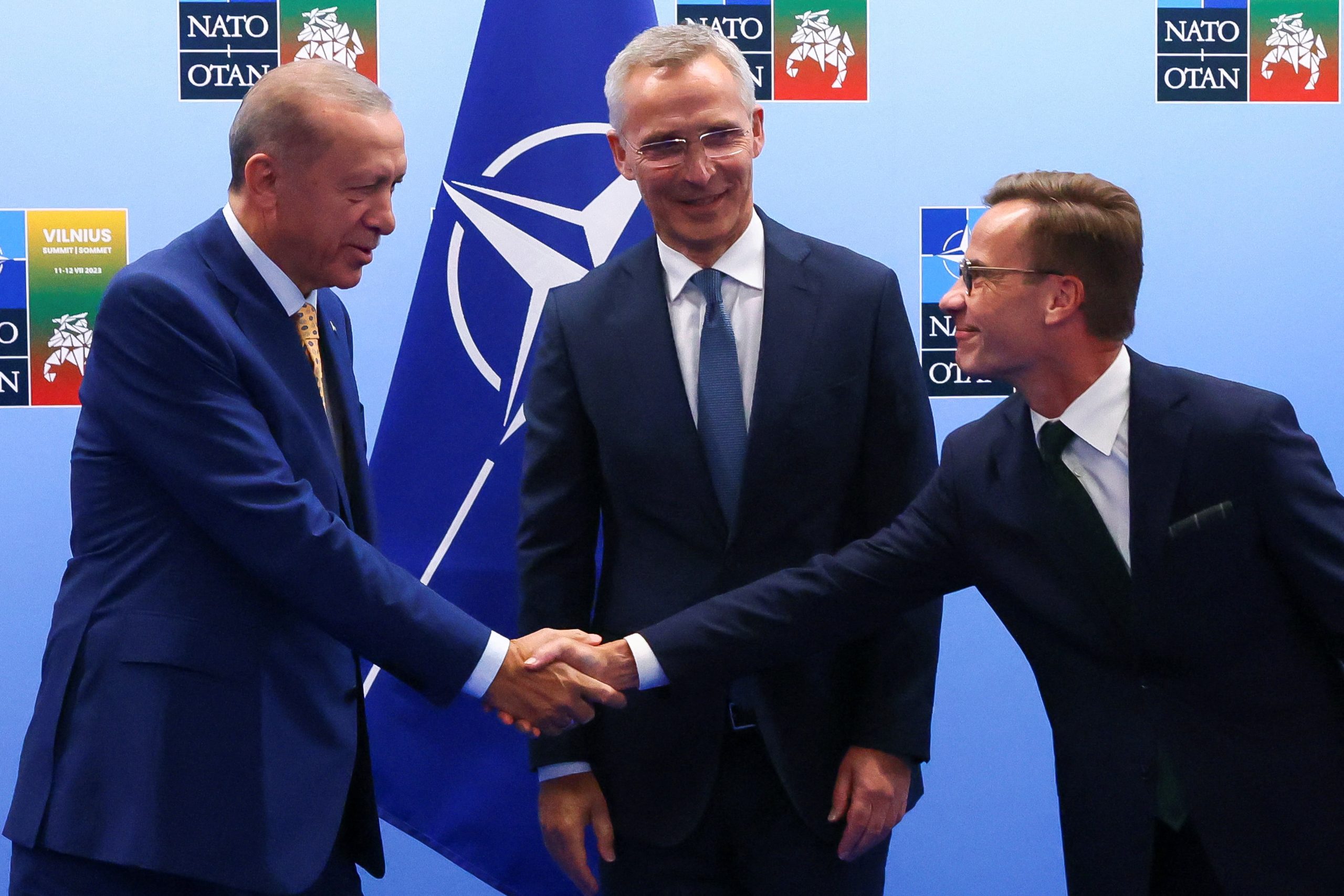 Turkish President Tayyip Erdogan and Swedish Prime Minister Ulf Kristersson shake hands next to NATO Secretary-General Jens Stoltenberg prior to their meeting, on the eve of a NATO summit, in Vilnius, Lithuania July 10, 2023.