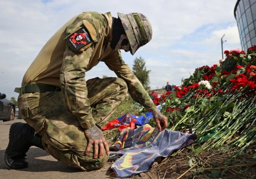 A masked Wagner fighter visits a makeshift memorial to Yevgeny Prigozhin in Saint Petersburg, Russia, August 24, 2023. (Source: Reuters/Anastasia Barashkova)