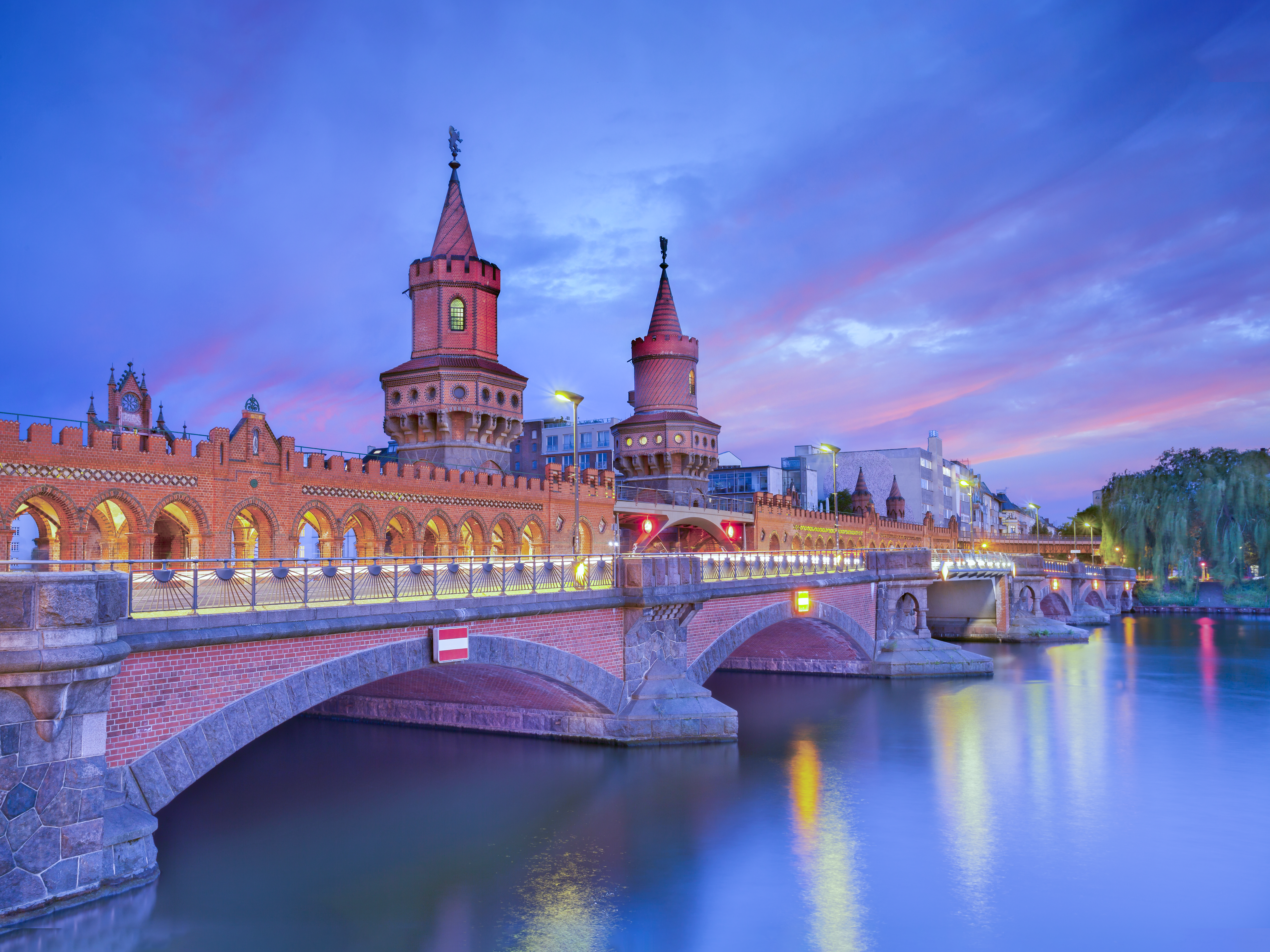 Image of the Oberbaum Bridge in Berlin, during a dramatic sunset. RudyBalasko via IStock
