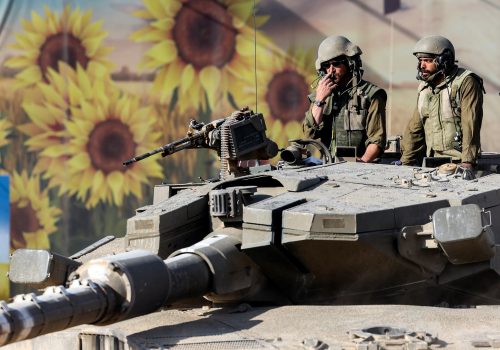 Israeli soldiers stand in a tank near Israel's border with the Gaza Strip, in southern Israel October 15, 2023. REUTERS/Ronen Zvulun