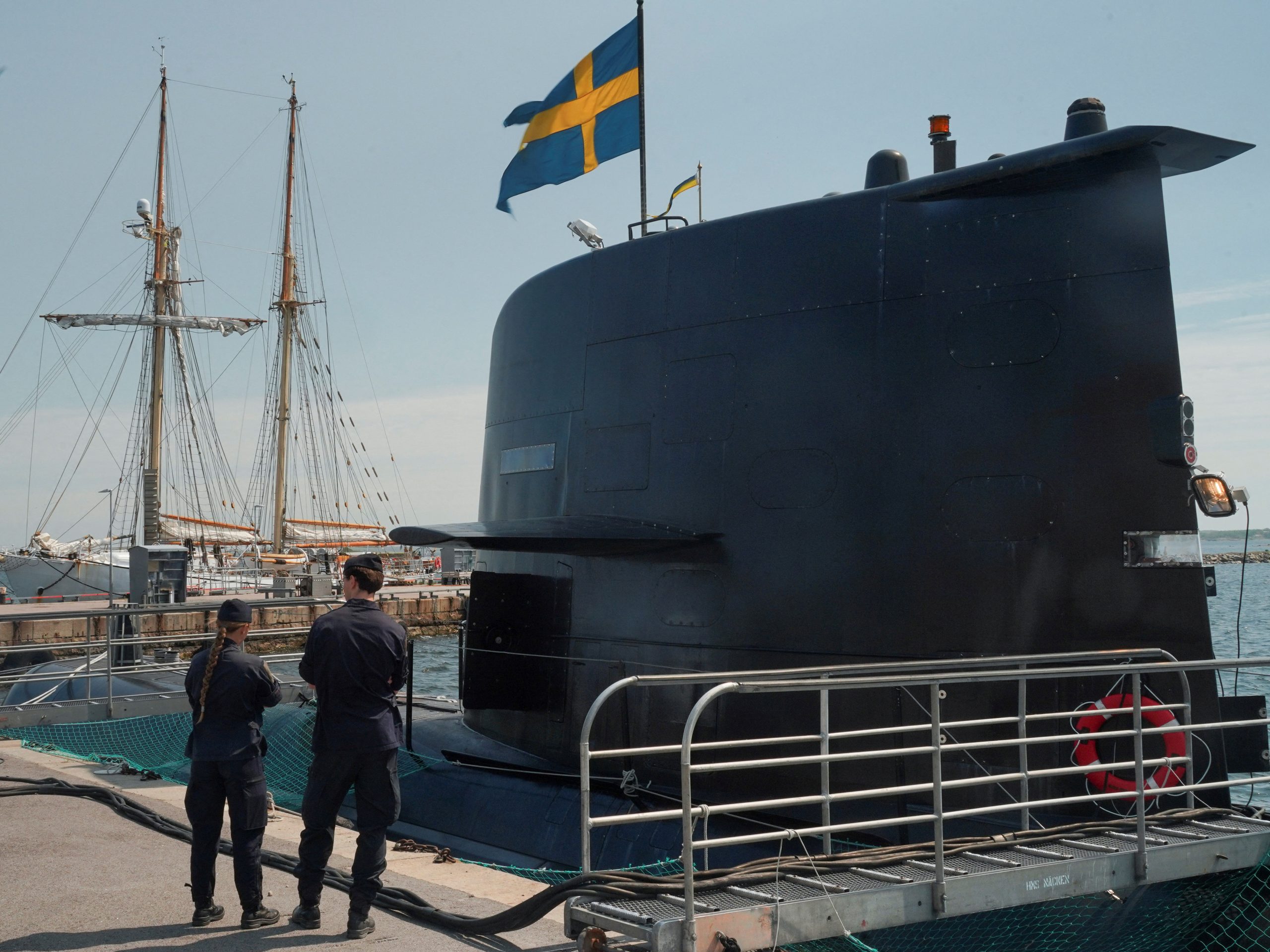 Sailors stand in front of the Swedish submarine HMS Gotland, as it lies in a port at the naval base of Karlskrona, Sweden May 25, 2023. REUTERS/Tom Little