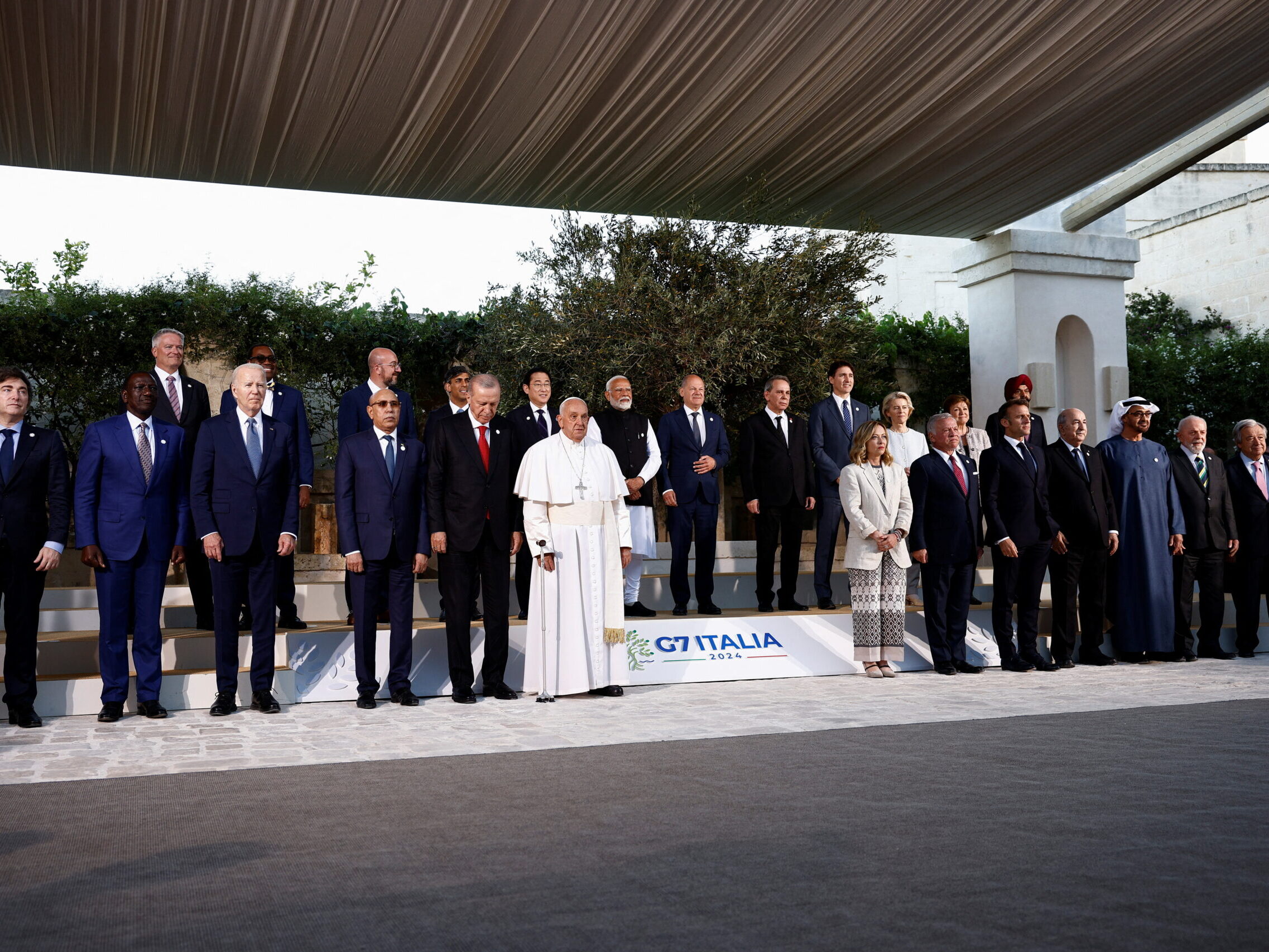 A group of approximately 25 people standing on a stage.