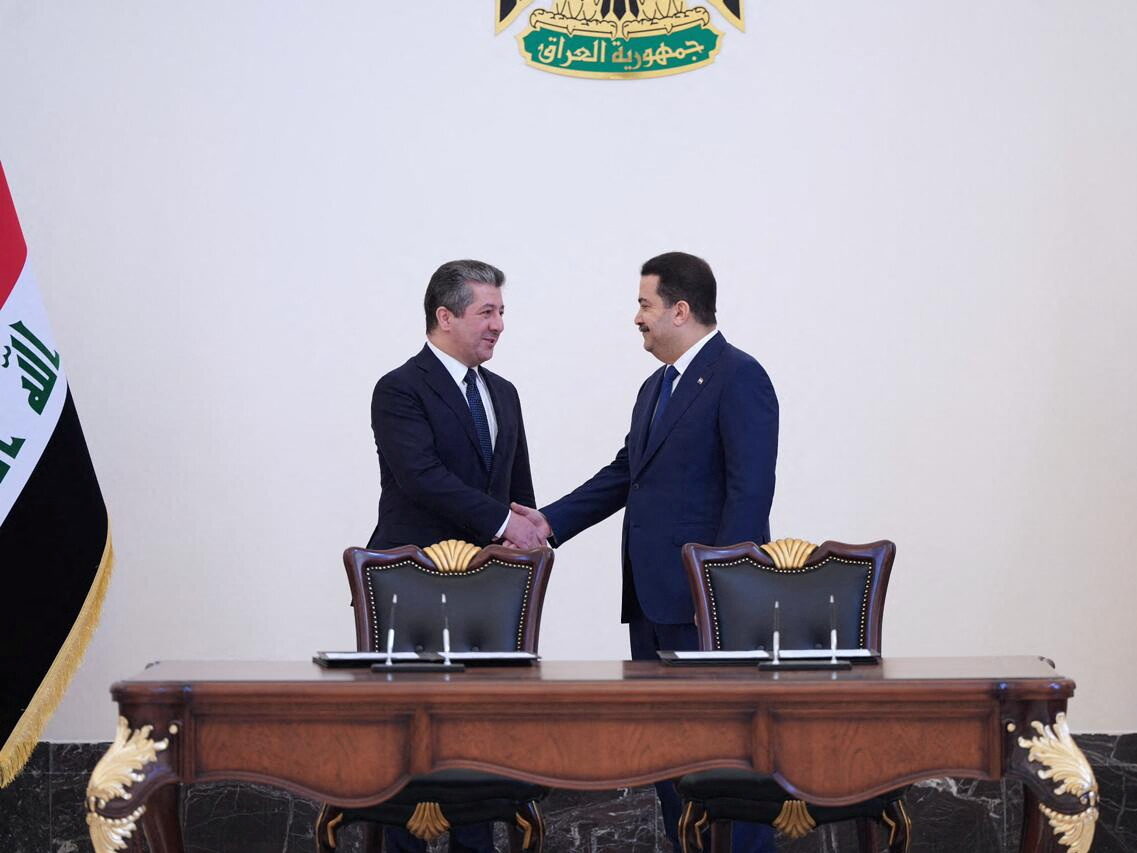 Iraqi Prime Minister Mohammed Shia al-Sudani and his Kurdish counterpart Masrour Barzani sign deal to restart northern oil exports in Baghdad, April 4, 2023.