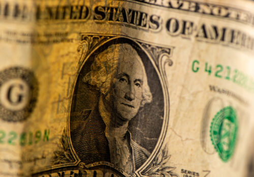One dollar bill folded on paper banknote. Business concept.