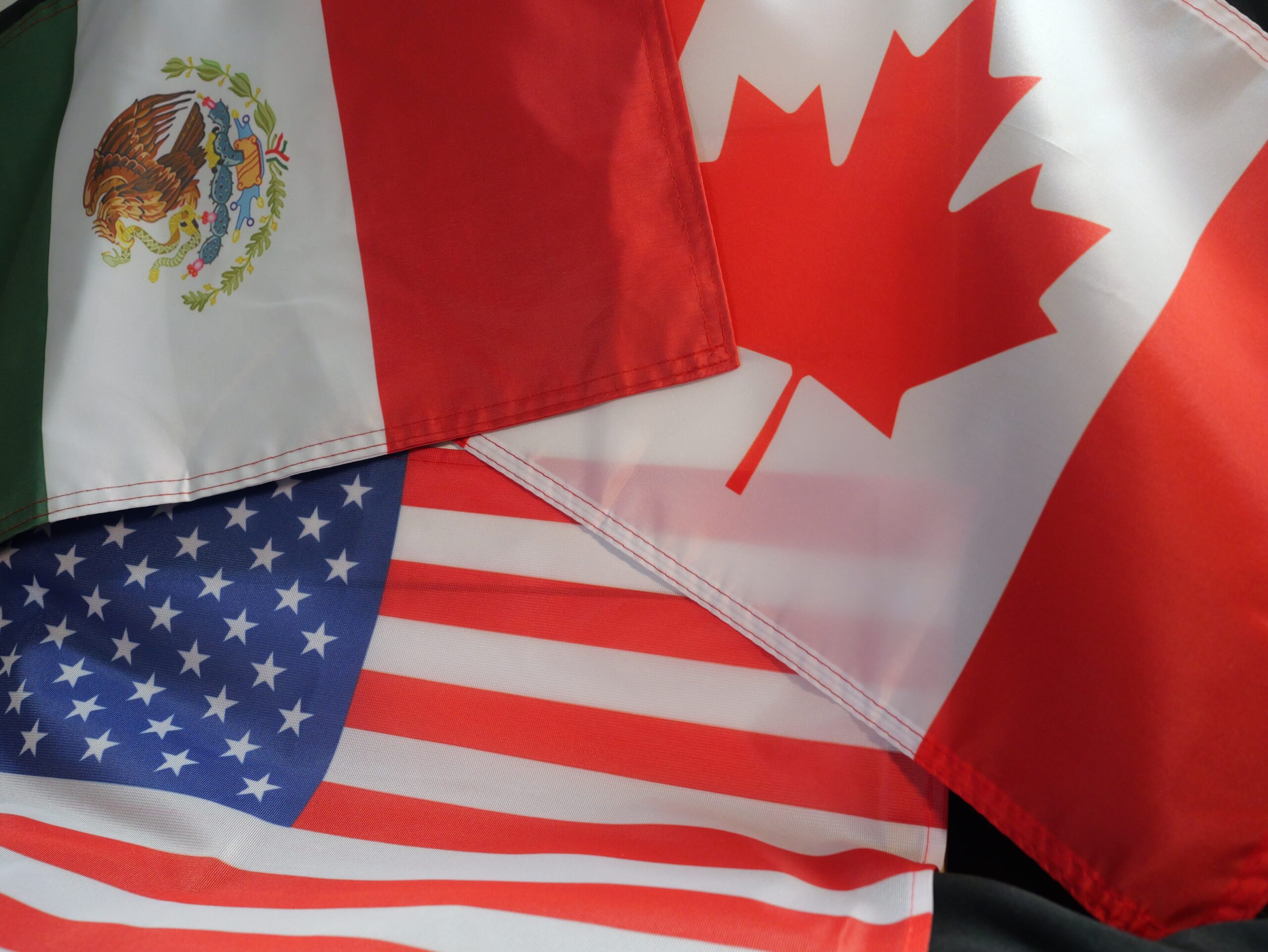 The flags of Canada, the United States, and Mexico